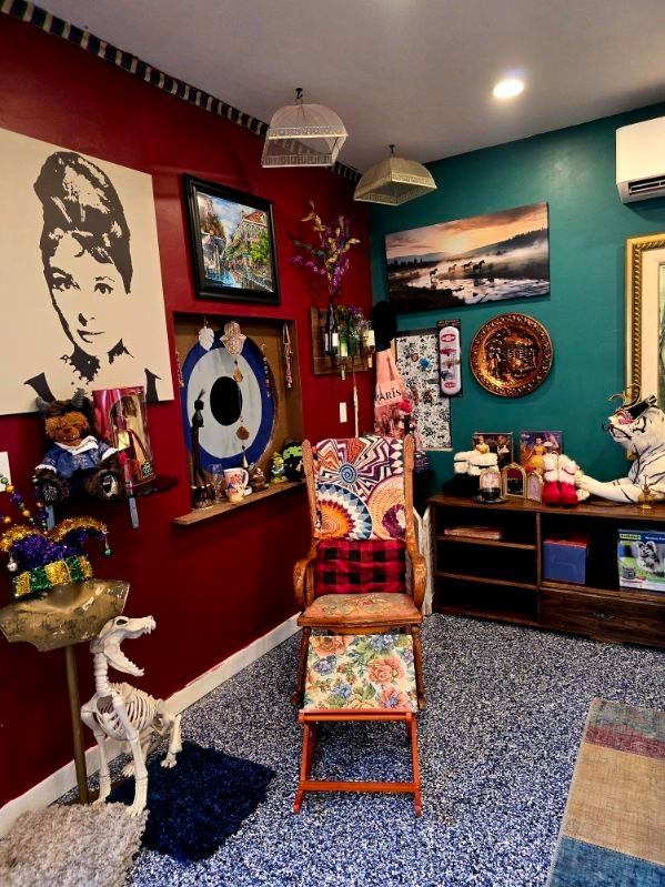 A curiosity corner with a vintage chair, skeleton figure, and eclectic vintage finds