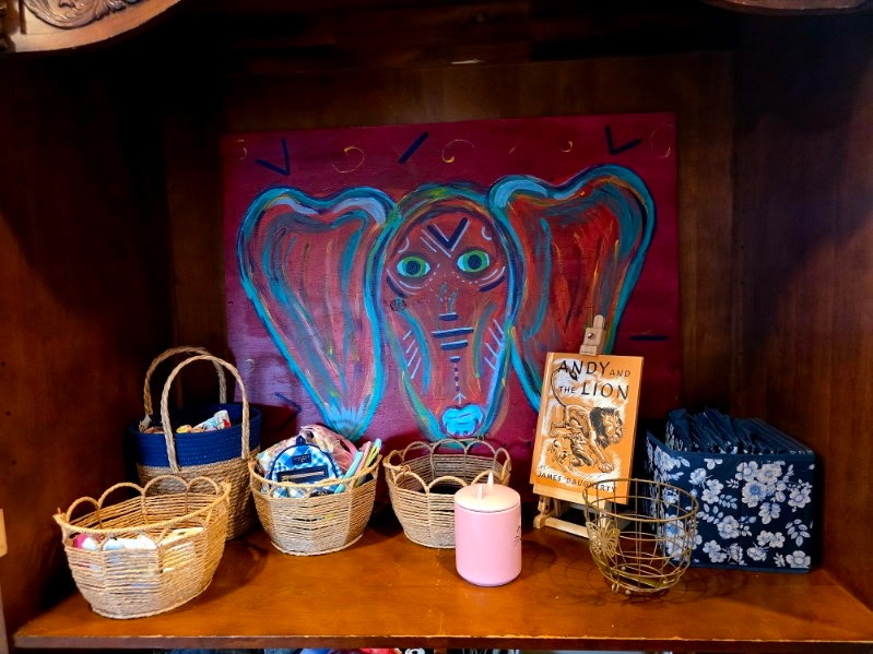 Original hand-painted canvas artwork displayed on a wooden shelf